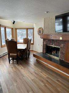 a dining room with a table and a fireplace at Keystone Lakeside Condo in Keystone