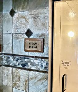 a sign that says steam room on a brick wall at Keystone Lakeside Condo in Keystone