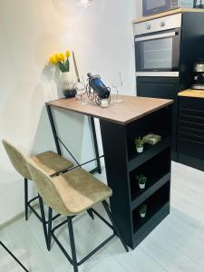 a kitchen with a counter with a desk and a chair at Apartman Jovičić in Bjelovar