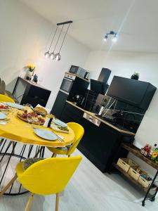 a dining room with a yellow table and yellow chairs at Apartman Jovičić in Bjelovar