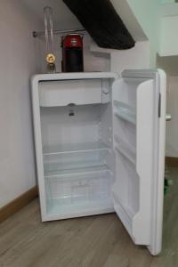 an empty refrigerator with its door open in a room at La Piccola Mole - Turin Cozy Apartment in Turin