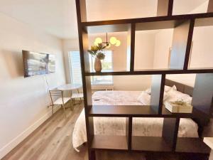 a room with a bed with a glass wall at The Rivet Apartments in Reno