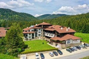 an aerial view of a large house with cars parked in a parking lot at N.Joy Holiday Apartment 532 by Oak Residence in Smolyan