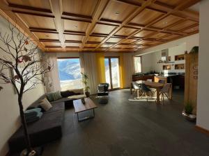 a living room with a couch and a table at Ferienwohnung Lenzerheide - Lain in Lenzerheide