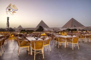 a restaurant with a view of the pyramids at Shadow Pyramids Palace in Cairo