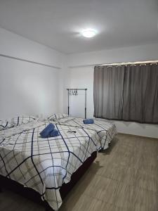 a bedroom with a bed with blue towels on it at Condomínio Beach Place Cumbuco in Caucaia +12 photos