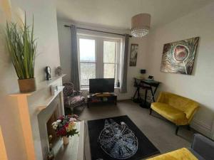 a living room with a fireplace and a couch at One/Two Bedroom Apartment Close to Sea & Centre in Hastings