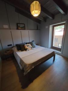a bedroom with a large bed and a window at Turisme Rural Ca l'Axai casa 1 in Pi +4 photos