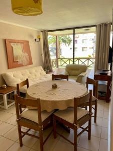 a living room with a table and a couch at QVEM Propiedades in La Serena