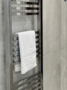 a bathroom with a towel on a towel rack at Kensington House by Solitaire Suites in Slough