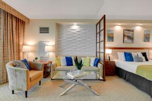a hotel room with a bed and a couch and chairs at Sin City Suite @ MGM Signature in Las Vegas +42 photos