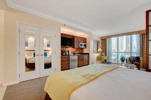 a large bedroom with a large bed and a kitchen at Sin City Suite @ MGM Signature in Las Vegas