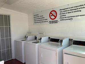 a row of washers and dryers in a room at Value Lodge in Alpine