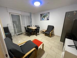 een woonkamer met een tafel en stoelen in een kamer bij Ferienwohnung in Saarbrücken in Riegelsberg