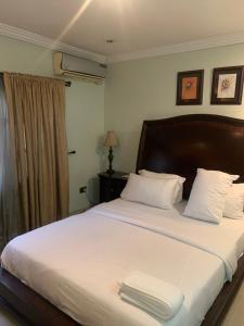 a bedroom with a bed with two towels on it at Tivoli Residence & Hotels in Lagos