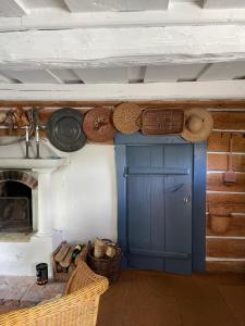 a room with a blue door and baskets and a fireplace at Stavsmyra in Eskilstuna