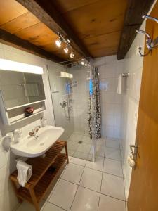 a bathroom with a sink and a shower at Chalet atypique Colorado Crans-Montana in Crans-Montana