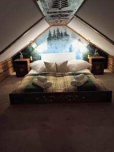 a bedroom with a large bed in a tent at Apartament Góralski Duet 8-osobowy - apartament na wyłączność in Bukowina Tatrzańska