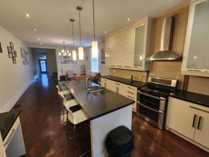 a kitchen with white cabinets and a counter top at Downtown Toronto Townhouse in Toronto