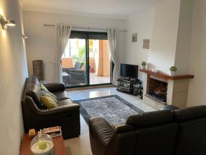 a living room with two leather couches and a fireplace at La Almadraba 412 in Manilva