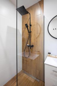 a shower in a bathroom with a glass door at Gorczański Zakątek in Konina