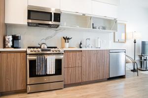 a kitchen with a stove and a microwave at Luxury Apartment With The Hollywood Hills View in Los Angeles