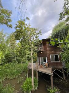 a tree house with a deck in the water at El octogono in Tigre