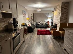 a kitchen and living room with a living room with a christmas tree at Harmony House enclosed property near beach and lake in Tramore