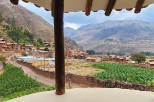 a view from a window of a village with mountains at Casa de campo en Rinconada Pisac in Cusco