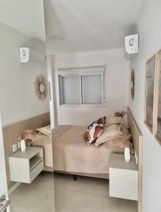 a bedroom with a dog laying on a bed at Apto decorado e bem localizado in Capão da Canoa