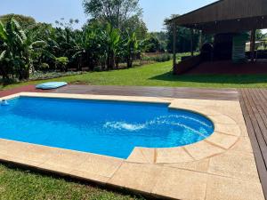 a large blue swimming pool in a yard at Casona Rural alquiler temporal in Puerto Rico +36 photos