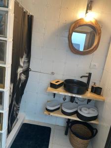 a small bathroom with a sink and a mirror at Casa luliche in Las Palmas de Gran Canaria