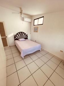 a bedroom with a bed and a tiled floor at Casa en Punta Barandua Playa Privada in Santa Elena