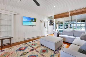 a living room with a couch and a table at Dare Street Family Getaway- Walk to beach + shops in Ocean Grove