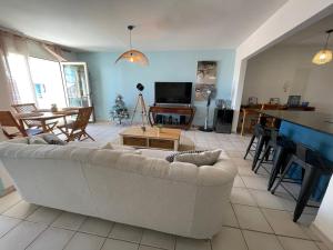 a living room with a couch and a table at LA PLAYA - L'Appartement COZY - 2 à 5 personnes in Sainte-Anne