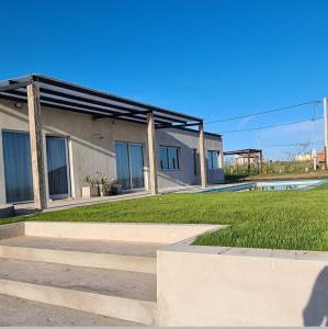 a building with some stairs in front of a yard at Quinta Loma Hermosa in Aldea Brasilera