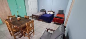 a living room with a table and a bed and a couch at Quinta Loma Hermosa in Aldea Brasilera