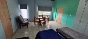 a room with a table and chairs and a dining room at Quinta Loma Hermosa in Aldea Brasilera +4 photos