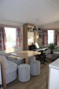 a living room with a table and some chairs at Cosy beachfront getaway in Mersea in West Mersea