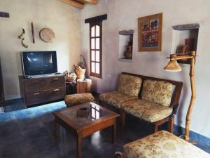 a living room with a couch and a tv at La Casa de Tilcara in Tilcara