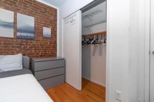 1 dormitorio con cama y pared de ladrillo en The Upper East Side Monthly Rentals Apartments, en Nueva York