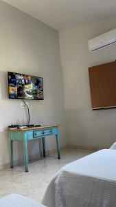 a blue desk in a room with a bed at Chalé da Picareta in São Roque de Minas