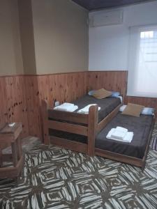 a bedroom with two beds and a table and a window at Depto Libres# in Paso de los Libres