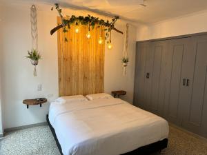 een slaapkamer met een groot wit bed in een kamer bij Rustik House in Medellín