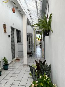 a patio with plants on the side of a building at Luso Apartamentos in Manaus