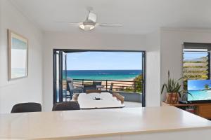 a living room with a view of the ocean at Acutterbove in Point Lookout