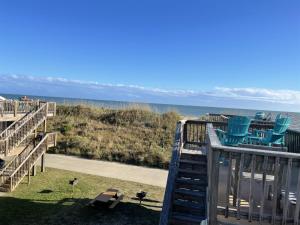 a deck with chairs and a view of the ocean at NC 12 56821-18 Condo in Hatteras