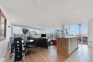 an open living room with a view of a city at Excel 3 Bedroom Apartment Near City Airport and O2 Arena in London