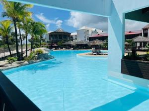 a pool at the resort at Appartement Manganao beach in Saint-François