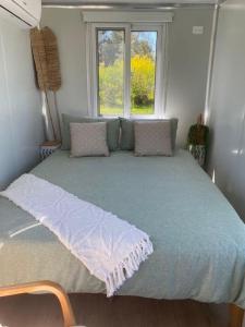 ein großes Bett in einem Zimmer mit Fenster in der Unterkunft Beachside Bungalows in Batemans Bay